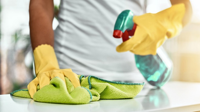 cleaning a kitchen benchtop with antibacterial cleaner